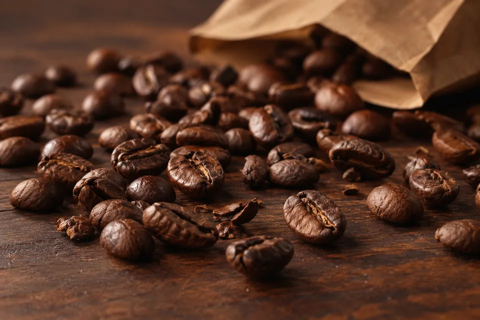 A close study of roasted coffee beans on a dark walnut surface